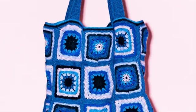 a blue and white crochet bag